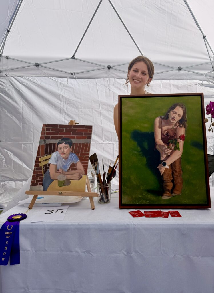 Hannah Julia Best in Show 2D winner Gulfport Fine Arts Festival 2026 with portrait paintings displayed at booth in Gulfport Florida